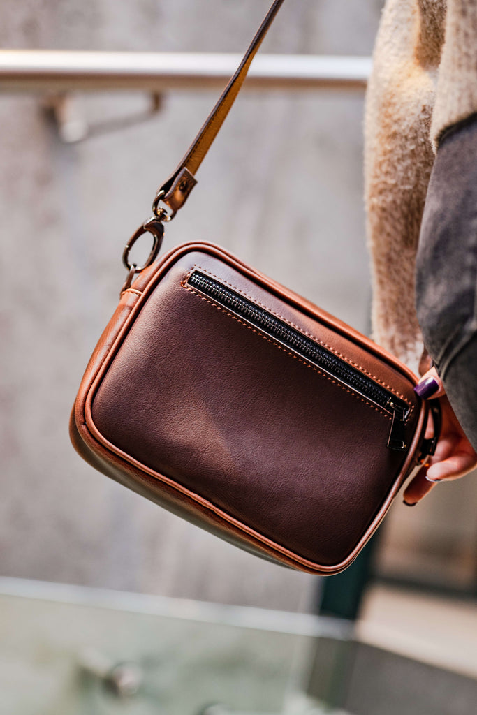 Close-up of brown vegan leather crossbody bag by Plant Inside, worn over the shoulder – elegant, handcrafted design that makes the perfect sustainable gift