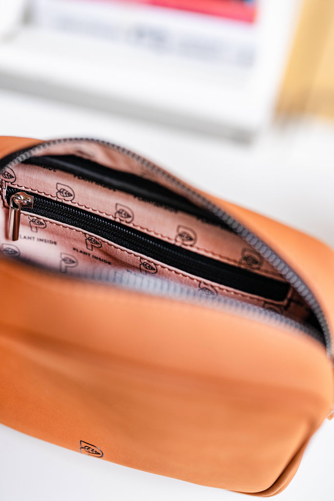 Close-up of Plant Inside vegan crossbody bag interior showing logo lining and zip pockets – high-quality craftsmanship built to last for years