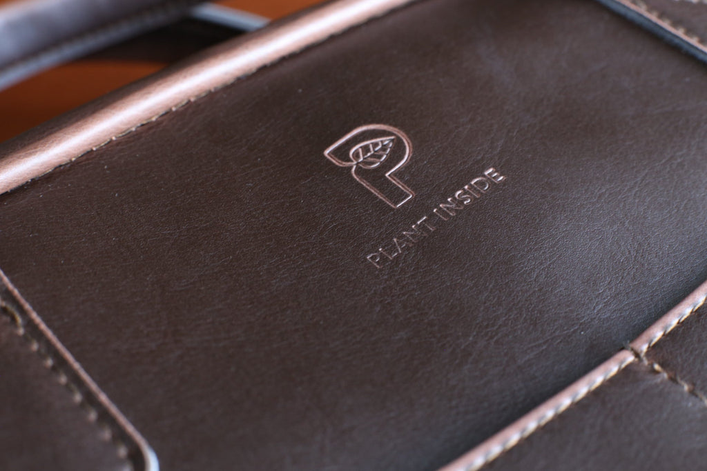 Close-up of Plant Inside laptop bag made from Viridis® vegan leather, showing embossed logo, texture, and stitching detail – symbol of sustainable craftsmanship