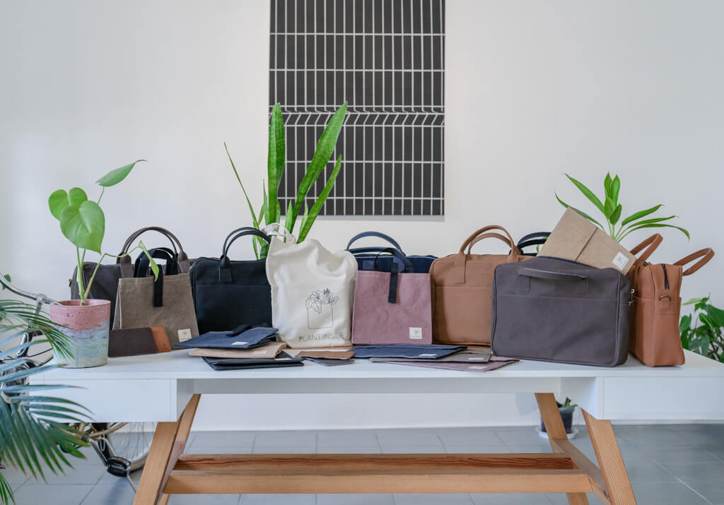 Collection of vegan Plant Inside products on a café table – stylish alternative to traditional leather