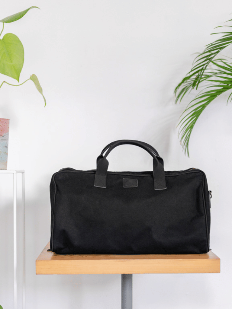 Black vegan weekend bag with matte finish and smart compartments